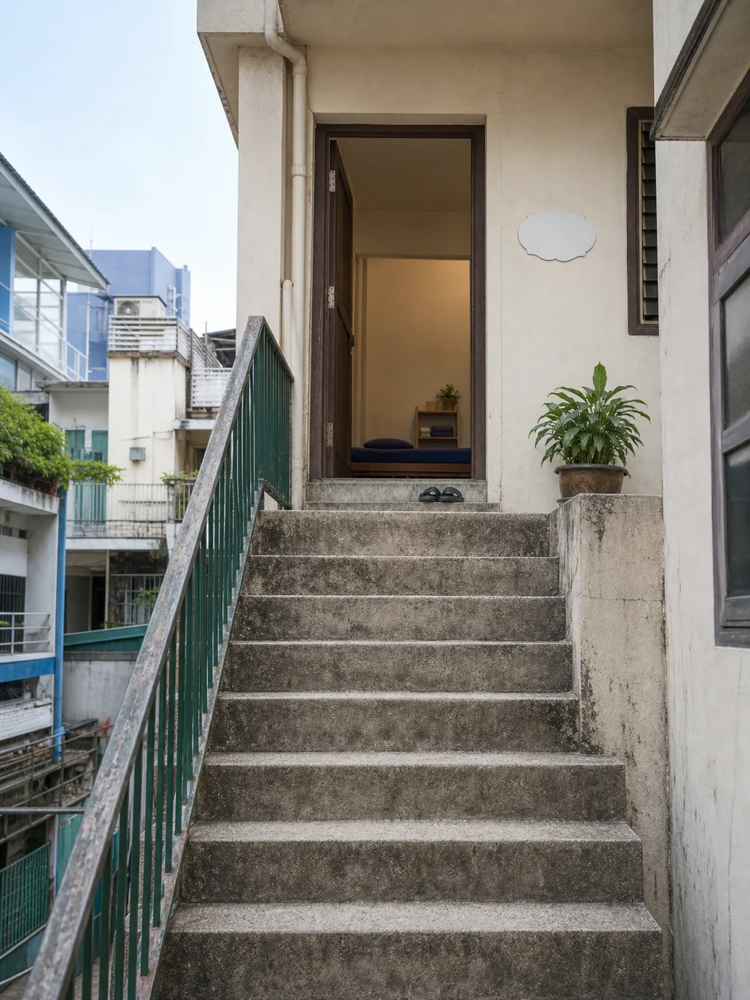 The outdoor stair from the street up to the walkway and the studio door